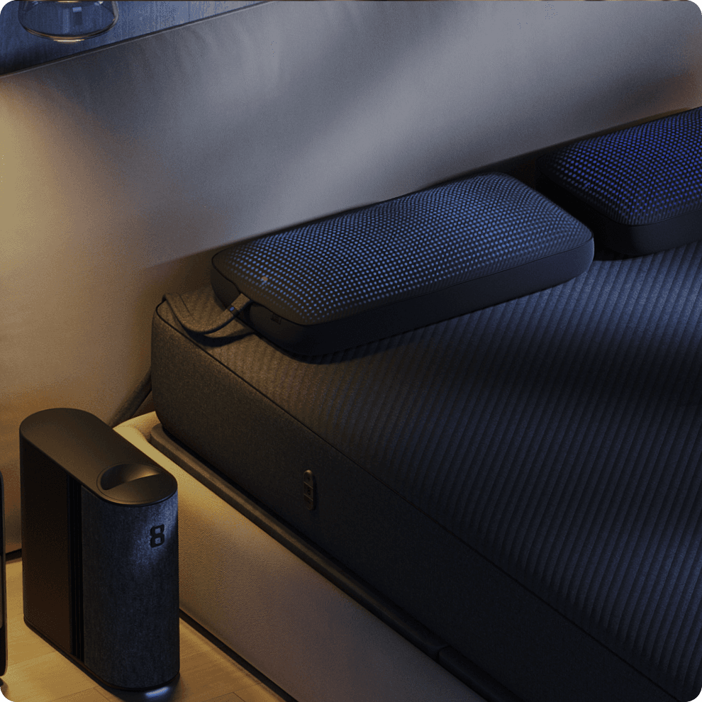 An Eight Sleep Pod beside a bed